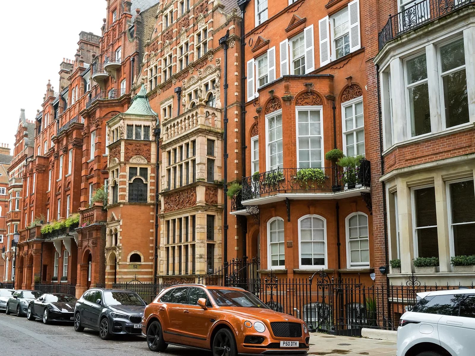 A row of London brick houses with sash windows and iron railings